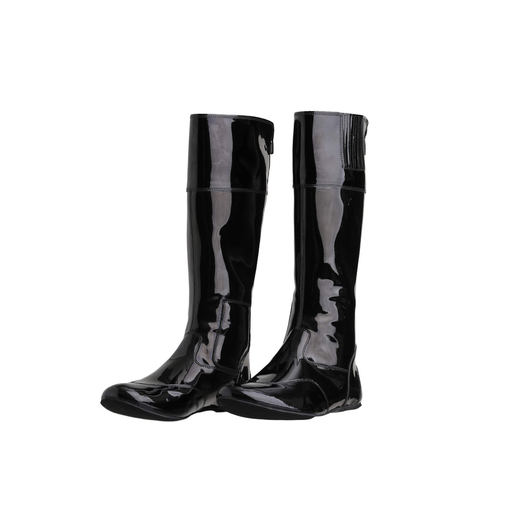 A pair of tall racing boots displayed against a white background. The boots are made of black material with black patent leather accents around the calf. They feature a back zip and a 1.5-2cm stretch feature around the calf. Both shoes are positioned sole down, with the zipper done and the angle of the boots slightly positioned to one side.