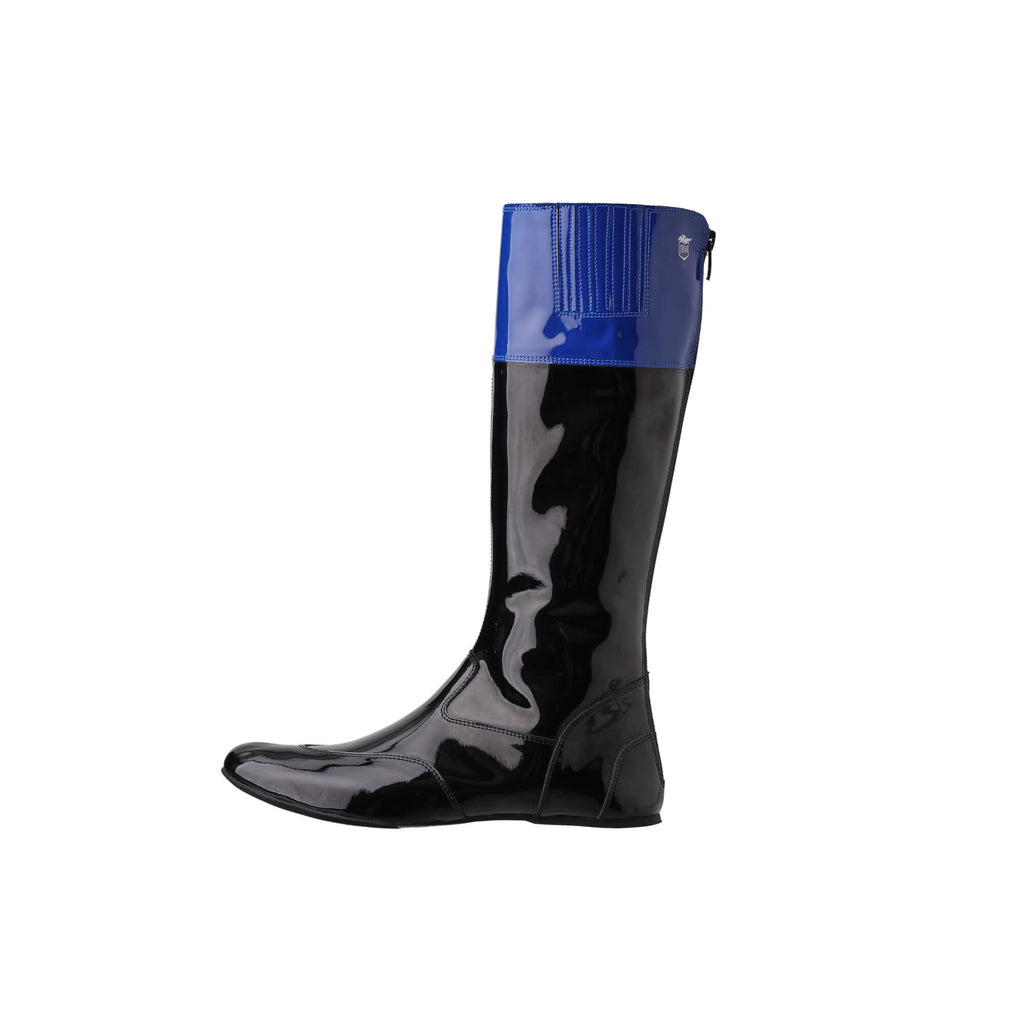 A single tall racing boot displayed against a white background. The boot is made of black material with blue patent leather accent around the calf. It features a back zip and a 1.5-2cm stretch feature around the calf area. The boot is shown from a side perspective.