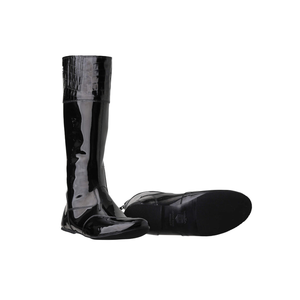 A pair of tall racing boots displayed against a white background. The boots are made of black material with black crocodile leather accents around the calf area. They feature a back zip and a 1.5-2cm stretch feature around the calf. One boot is positioned sole down with the zipper done, while the other boot is laid down to showcase the sole.