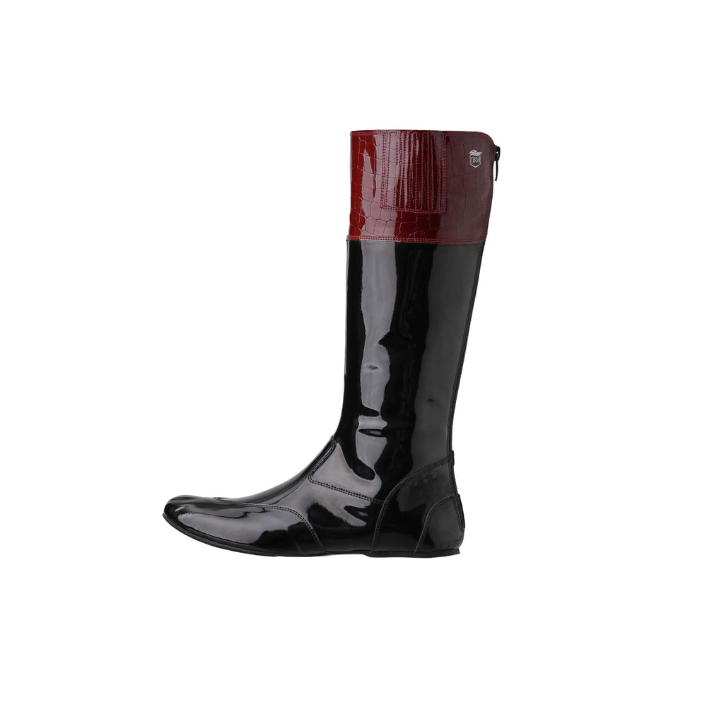 A pair of tall racing boots with black material and burgundy crocodile leather accents on the calf, displayed on a white background. The boots feature a back zip and a 1.5-2cm stretch feature around the calf. They are made of light, tough, flexible, and strong black material. The image showcases the boot from a side perspective.