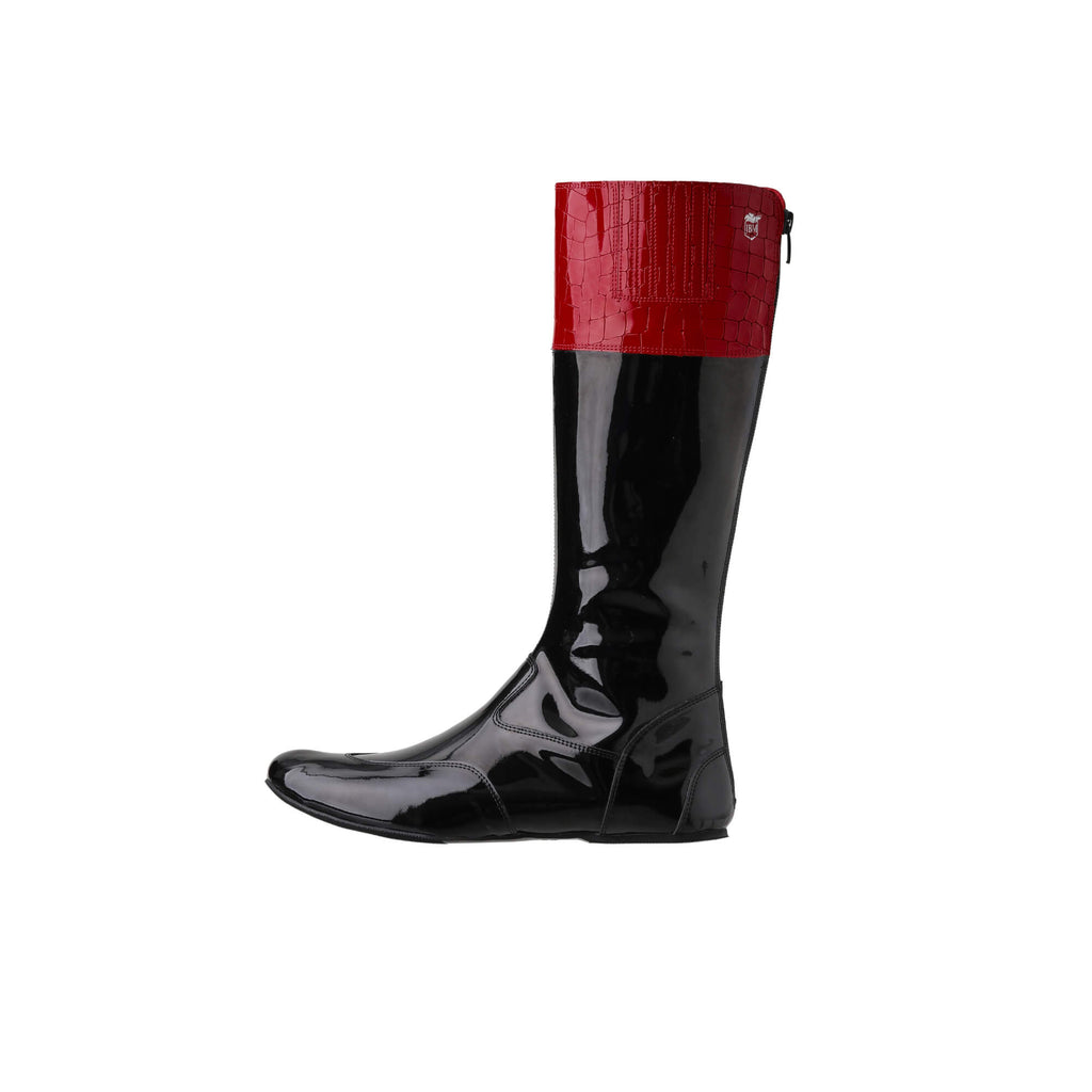 A  tall racing boot against a white background. The boot is made of black material with red crocodile leather accents around the calf. It features a back zip and a 1.5-2cm stretch feature around the calf. This image showcases one boot from a side perspective.