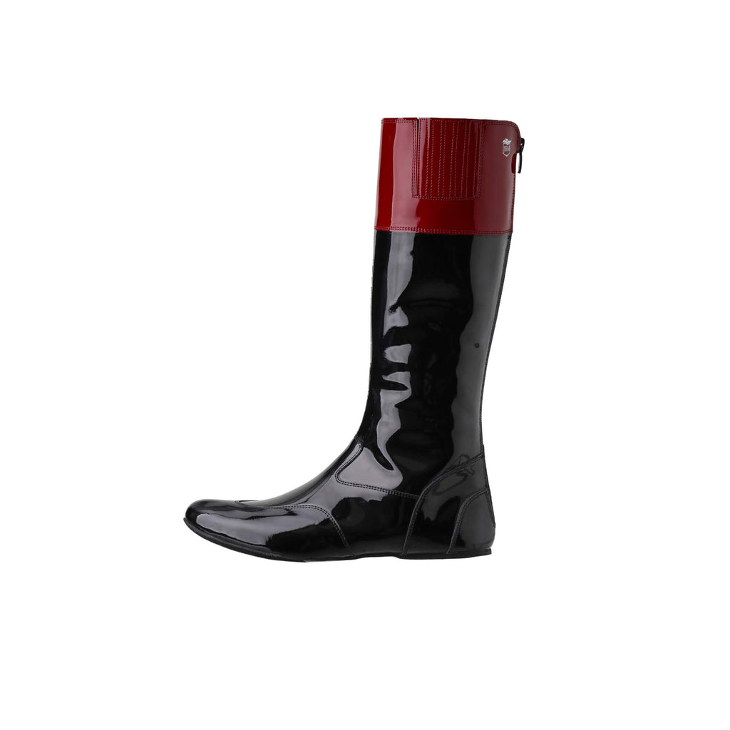 A tall racing boot displayed against a white background. The boot is made of black material with a dark red patent leather accent around the calf area. It features a back zip and a 1.5-2cm stretch feature around the calf. This image only showcases one boot from a side perspective.