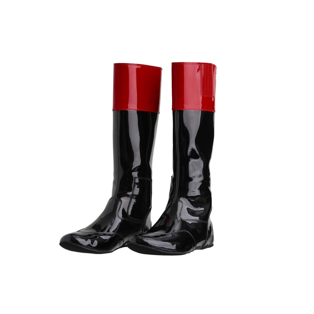 Tall racing boots with black material and red patent leather accents on the calf, displayed on a white background. The boots feature a back zip and a 1.5-2cm stretch feature on the calf area. They are made of light, flexible, and strong material. Both boots are positioned sole down with the zipper done, angled slightly to one side.