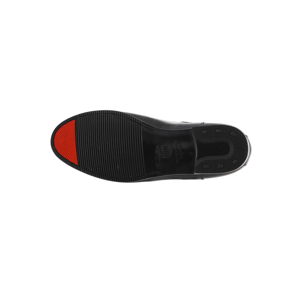 One classic black short boot, featuring a slide-on design, laid down to highlight the sole with a signature red tip, all against a white background.