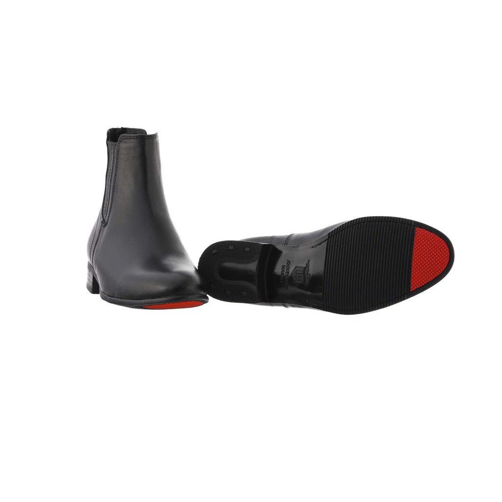 A pair of short classic black leather boots featuring a back zip, presented on a white background. One shoe is displayed sole down with the zipper securely fastened, while the other shoe is laid down to showcase the sole, featuring a red tip as their signature sole design.