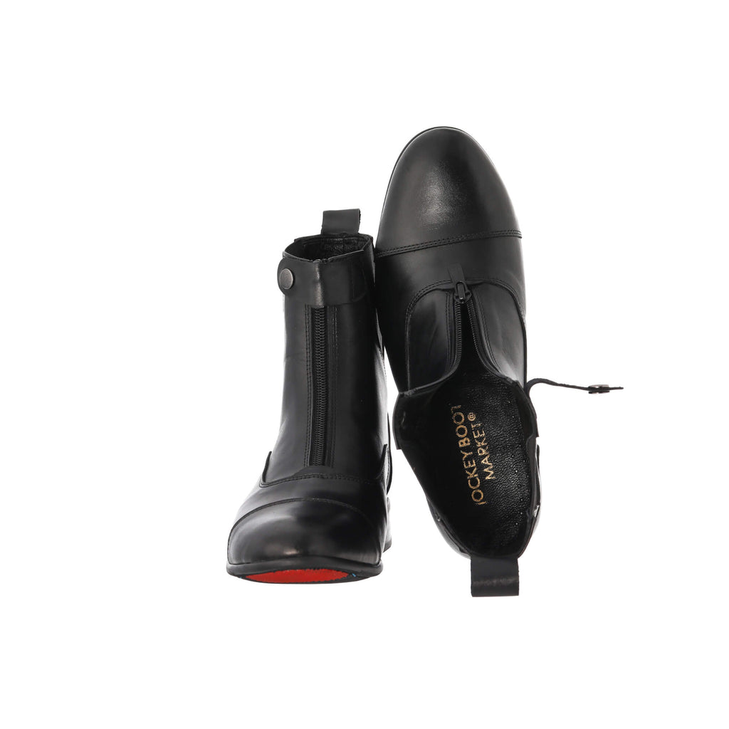 A pair of classic black boots with a front zip and buckle, showcased on a white background. The first shoe's sole is placed on the floor, with the buckle and zip fastened. The second shoe is displayed upside down to reveal the interior, with the buckle and front zip undone.