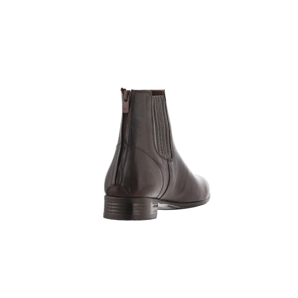 A back view of a classic brown leather boot with a back zip closure, displayed against a white background.