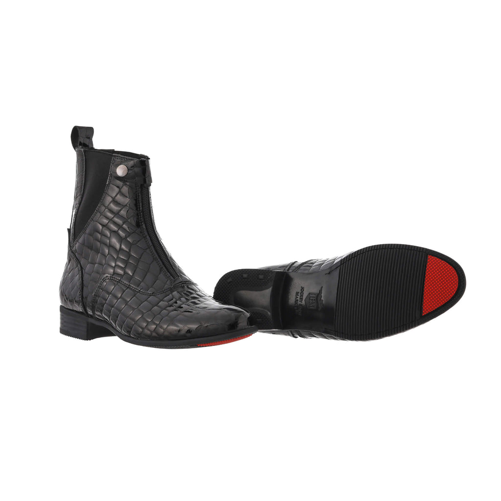 A pair of black crocodile leather short boots with a front zip and buckle, set against a white background. One shoe is showcased sole down, with the buckle and zip done, while the other shoe is laid down to highlight the sole, featuring a red tip as their signature design.