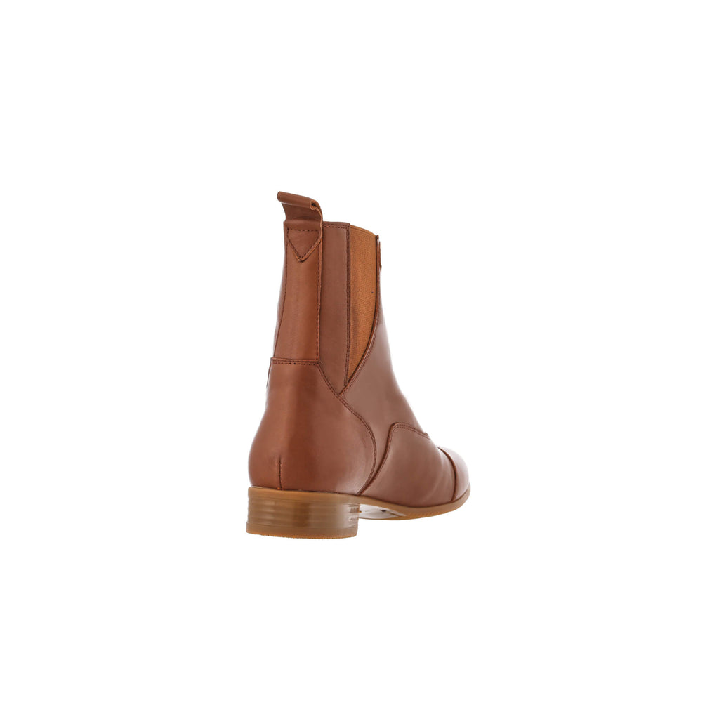 A back perspective of a tan leather short boot featuring a front zip and a buckle, against a white background.