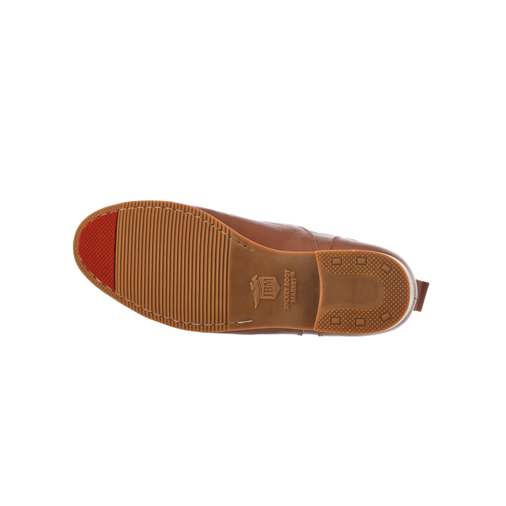 One tan leather short boot laid down to display its sole with a red tip, featuring a front zip with buckle, against a white background.