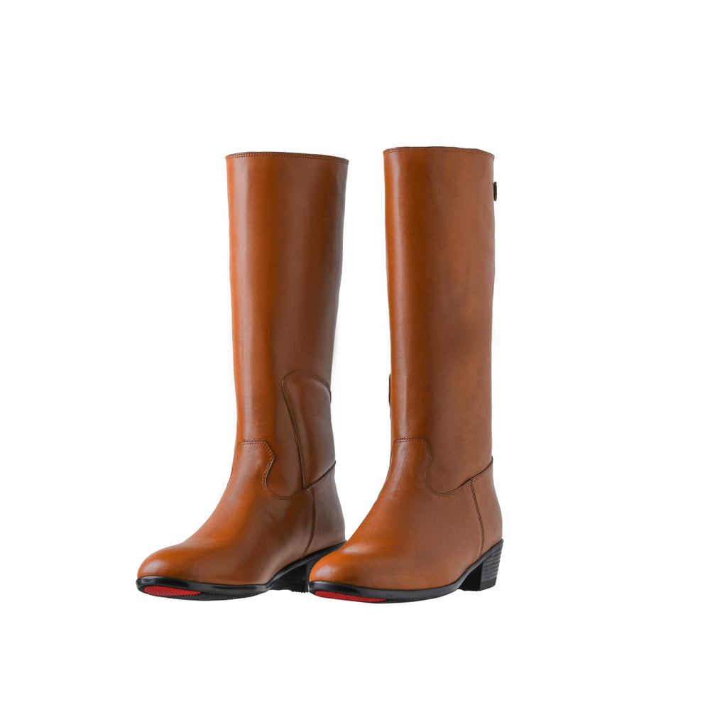 A pair of tall tan leather Cuban heel boots featuring a back zip, displayed against a white background. Both shoes are positioned sole down with the zipper done, with the angle of the boots slightly positioned to one side.