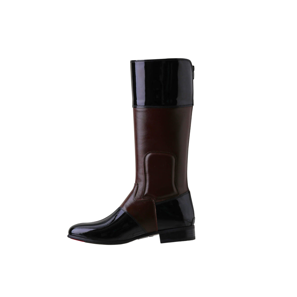 A side view of a brown tall boot with black patent accents on the top and bottom. Features a back zip and a 1.5 - 2cm ability to loosen the calf area if required. Displayed against a white background.