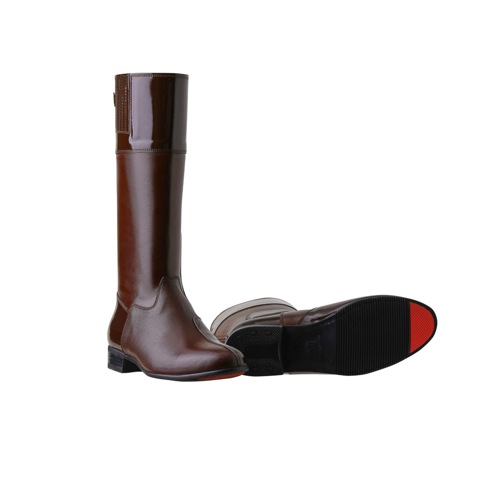 A pair of tall racing boots displayed against a white background. Made of brown leather with brown patent leather wrapping around the calf, they feature a back zip and a 1.5-2cm stretch feature on the calf area. One boot is positioned sole down with the zipper done, while the other boot is laid down to showcase the sole, which features a red tip design.