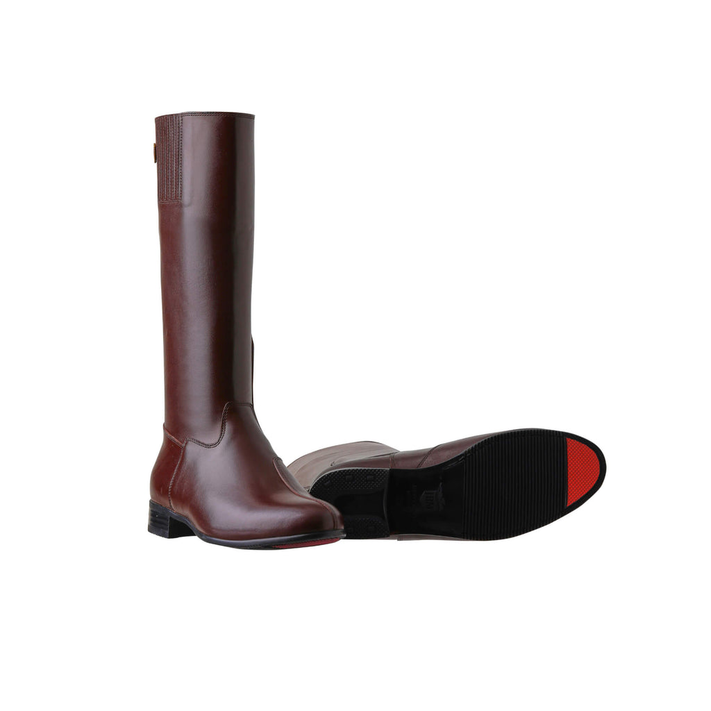 A pair of tall brown leather boots with a back zip and a 1.5-2cm stretch feature on the calf area. Displayed against a white background, one boot is positioned sole down with the zipper done, while the other boot is laid down to showcase the sole featuring a red tip design.