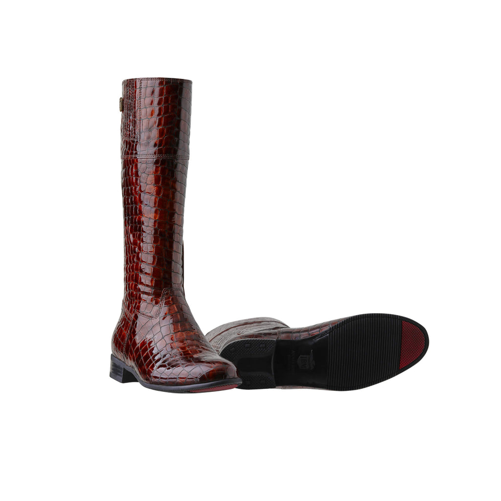 A pair of brown crocodile leather tall boots featuring a back zip and a 1.5 - 2cm ability to loosen the calf area if required. Displayed on a white background. One boot is shown sole down with the zip done. The other boot is laying down to showcase the sole with a red tip design.