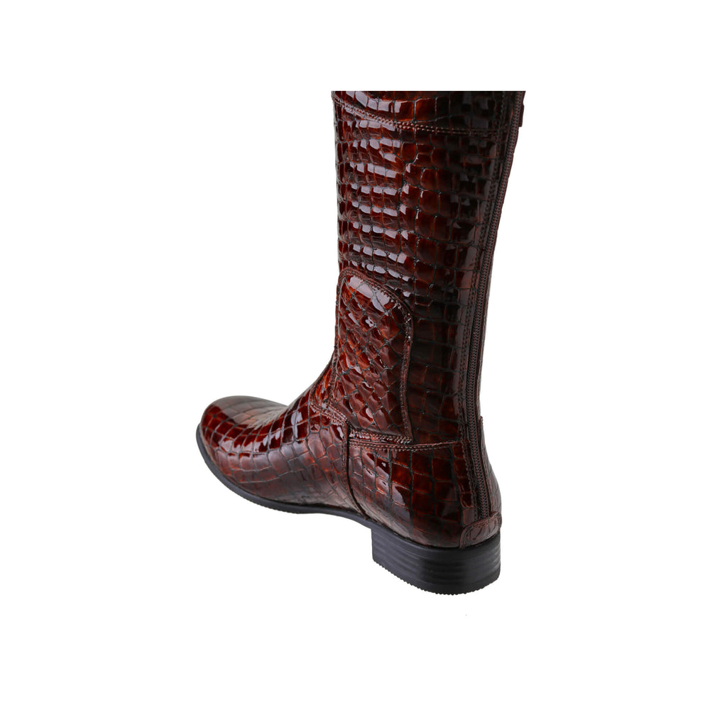 A pair of brown crocodile leather tall boots featuring a back zip and a 1.5 - 2cm ability to loosen the calf area if required, displayed against a white background. The image presents one boot from the back perspective, with the zip done.