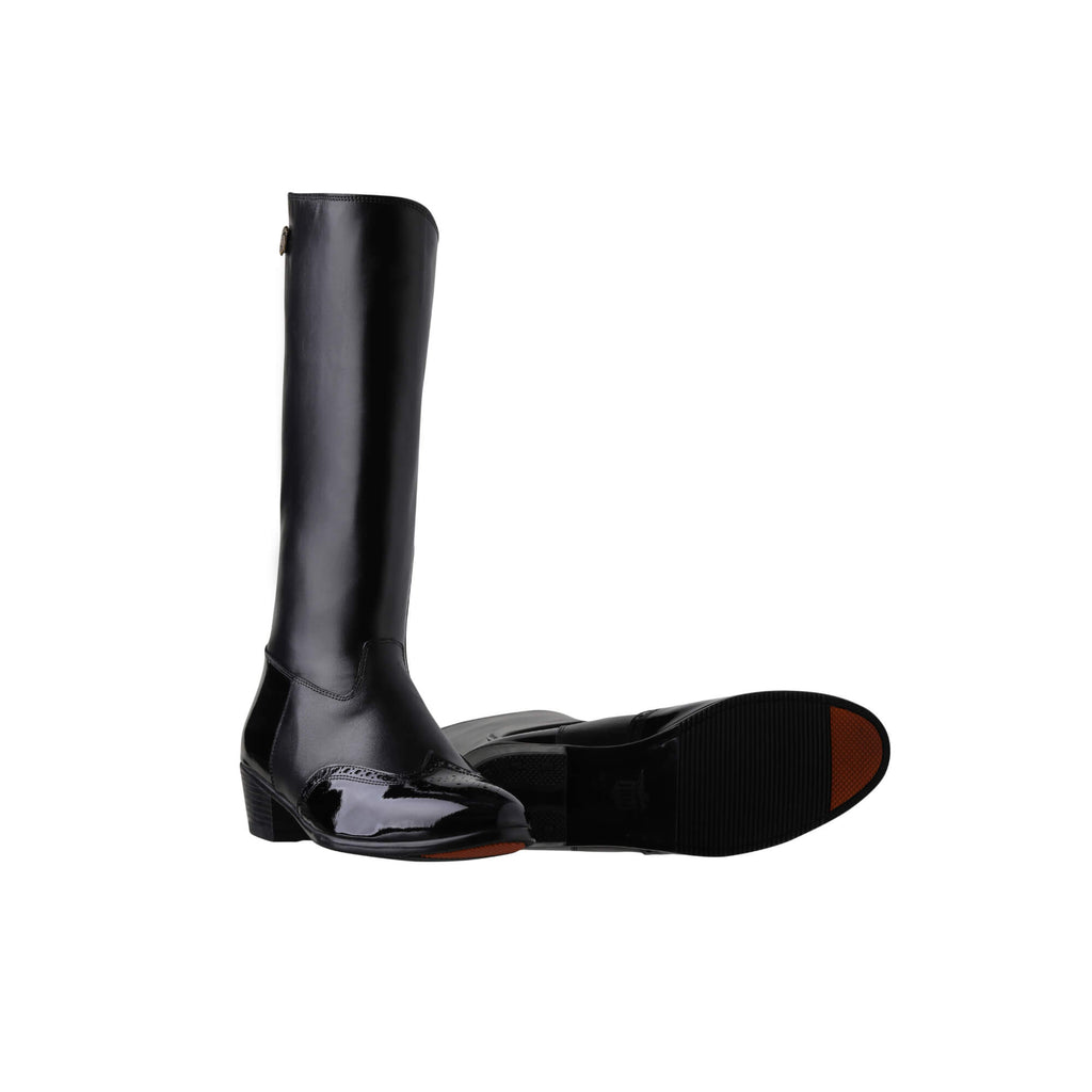 Tall black leather Cuban heel boots with black wingtip-style accents. They feature a back zip and are displayed against a white background. One boot is positioned sole down with the zipper done, while the other boot is laid down to showcase the sole, which features a red tip design.