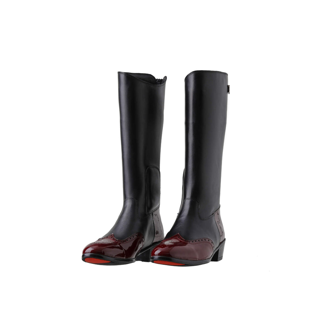 A pair of tall black leather Cuban heel boots with burgundy wingtip accents. The boots feature a back zip and are displayed against a white background. Both shoes are positioned sole down with the zipper done, and the angle of the boots slightly positioned to one side.